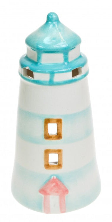 A ceramic tealight holder designed to resemble a lighthouse, with white, blue, and pink colors and a lighthouse-like structure.