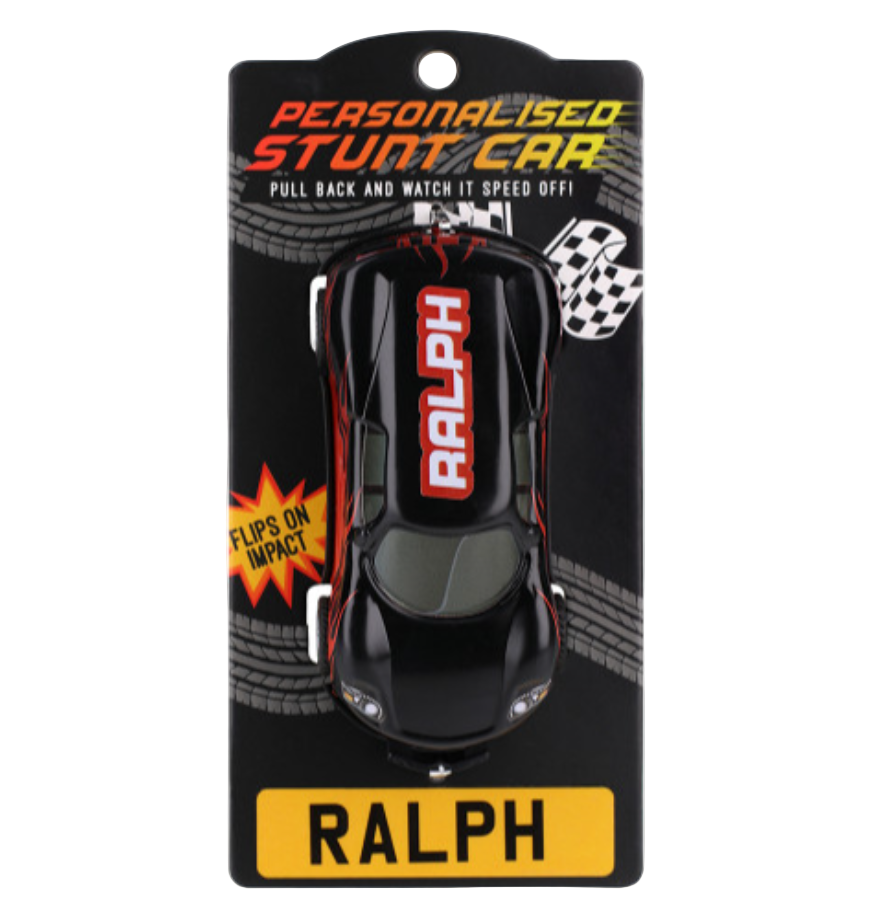 A personalized stunt toy car named 'RALPH' in black color, packaged on a black backing card with the name displayed prominently at the bottom.