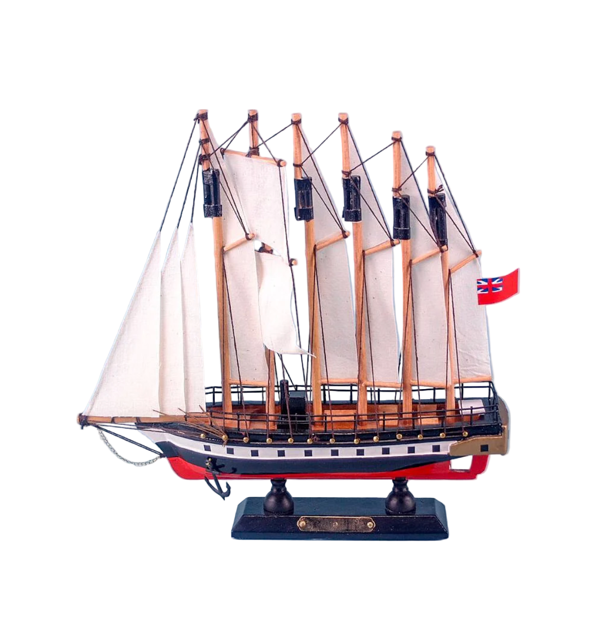 Model ship with multiple masts and sails on a light blue background