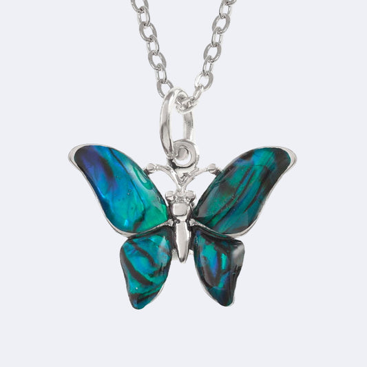 A blue paua shell pendant in the shape of a butterfly, attached to a silver trace chain.
