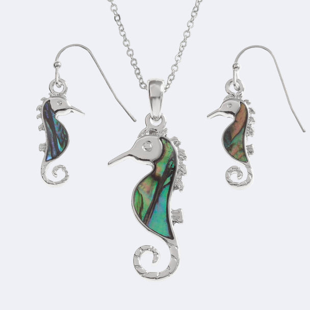 A set consisting of a seahorse pendant necklace and a pair of hook earrings, with both featuring a paua shell design on a silver-colored base.