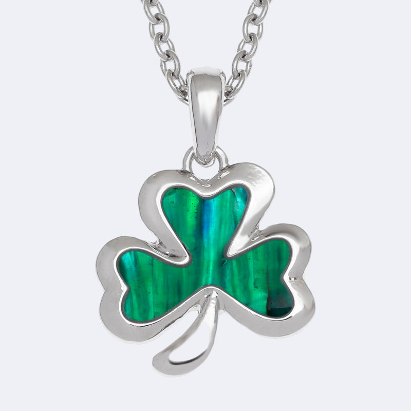 Silver necklace with a green shamrock pendant on a white background