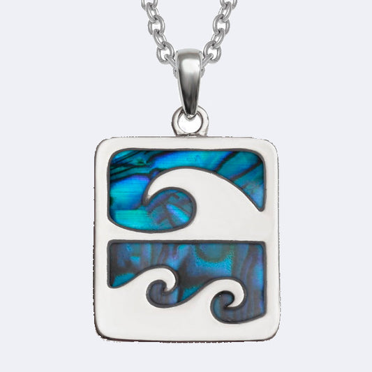 A silver necklace with a turquoise and black wave crest design on a square-shaped pendant.