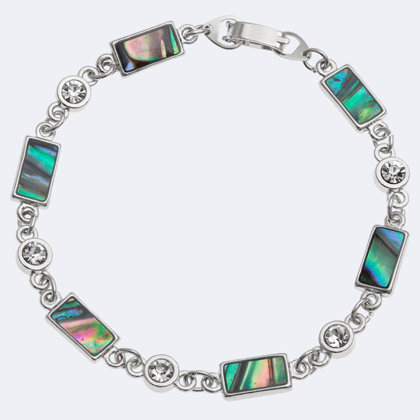 A bracelet with rectangle sections featuring natural Paua shell and inset glass stones, with rhodium plating.