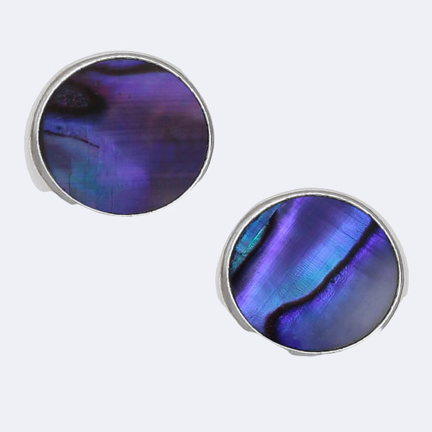 A pair of round stud earrings featuring purple Paua shell, set in a circular silver frame.