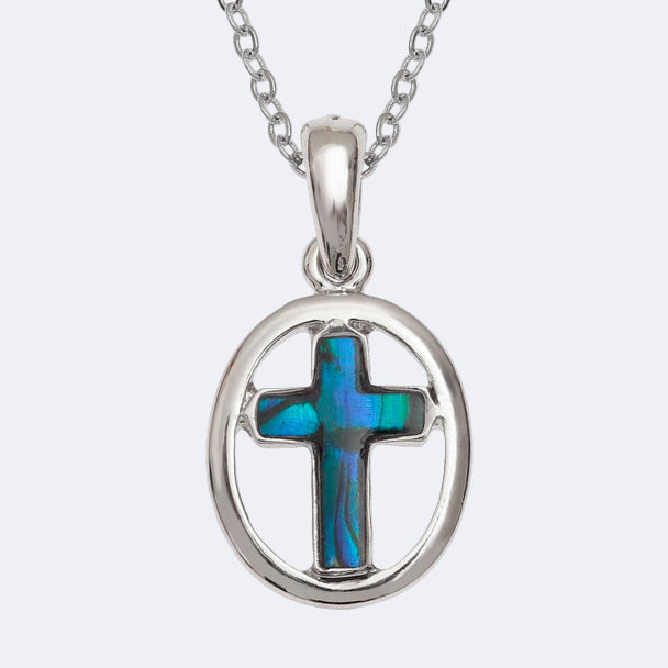 A blue oval cross necklace with a Paua shell pendant on a silver chain, presented in a box.