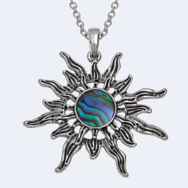 Sun-shaped pendant with abalone shell center on a white background