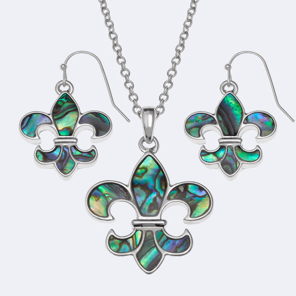 A silver-colored necklace with a fleur-de-lis design and a matching pair of earrings, both featuring a central Paua bead surrounded by silver metal.