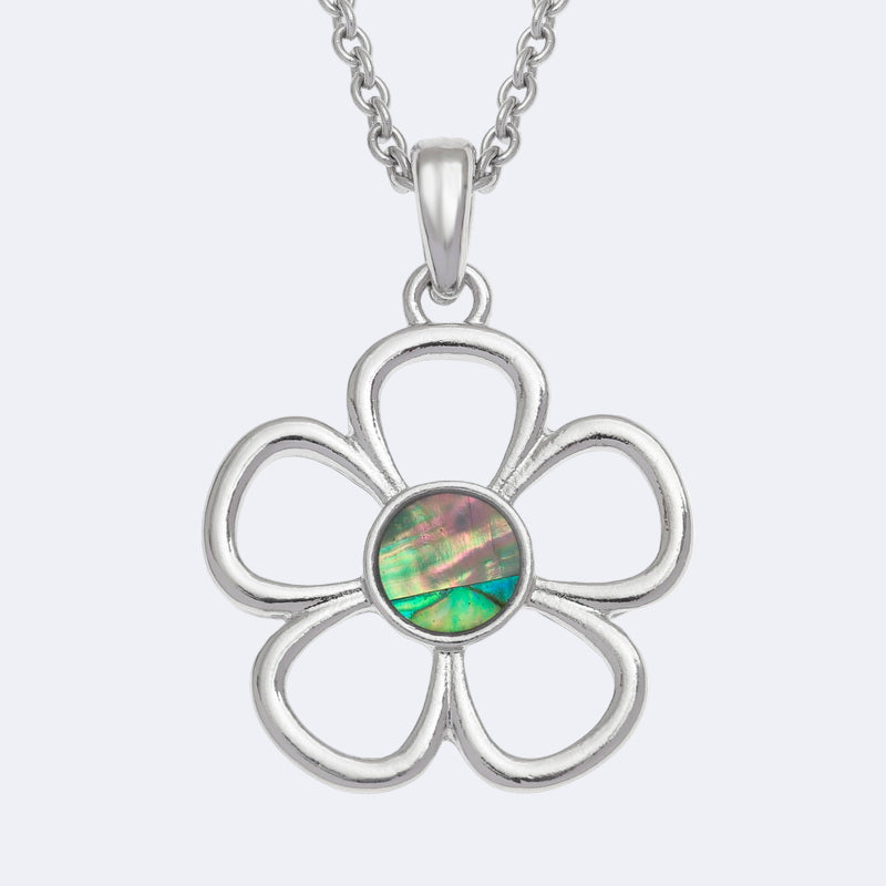 Silver flower-shaped pendant with a green paua shell centre on a white background
