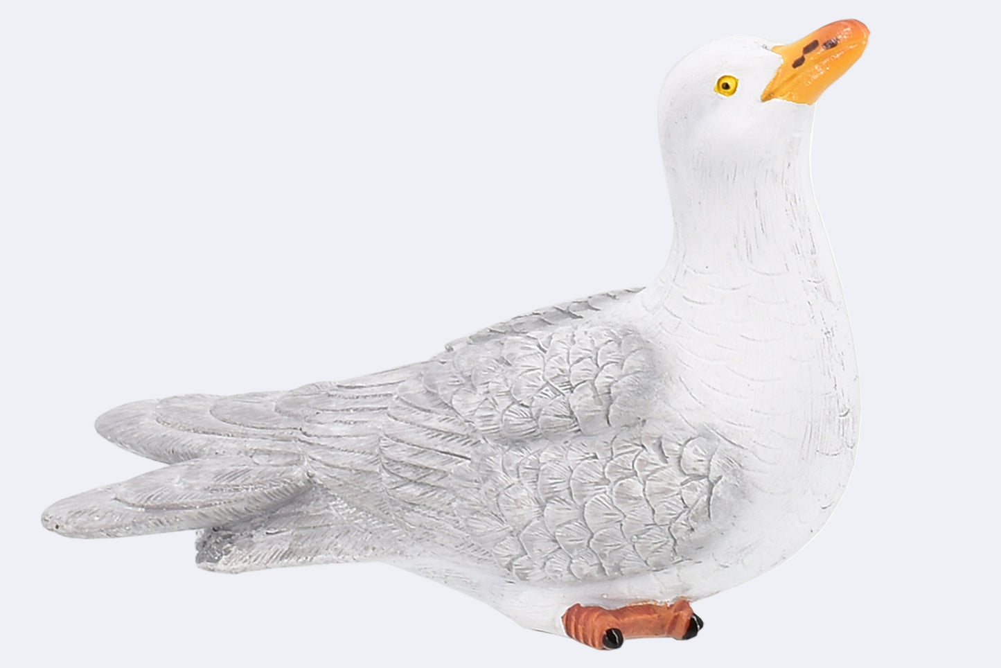 A resin figurine of a seagull with white feathers, a yellow beak, and orange feet.
