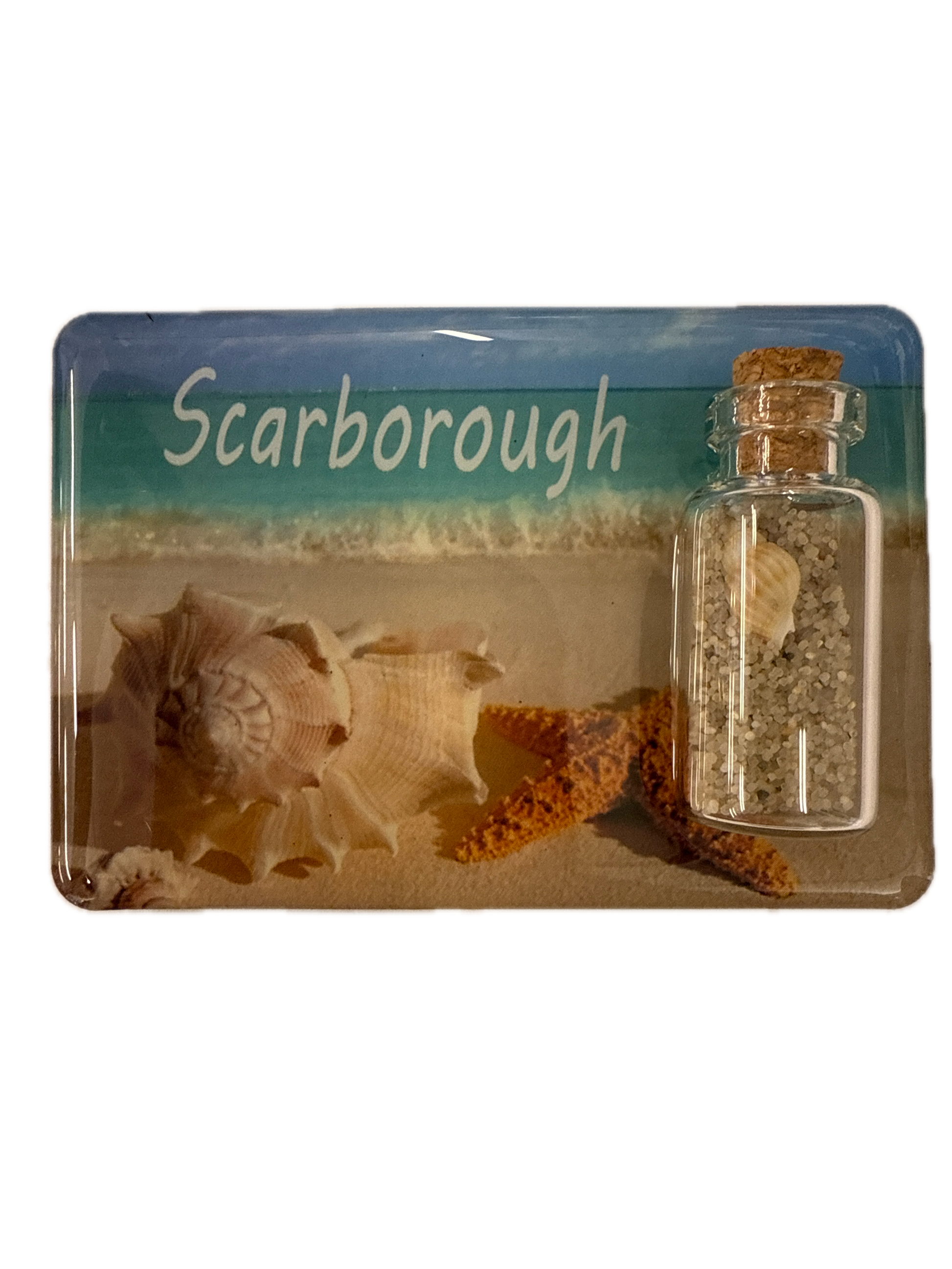 Fridge magnet with seashells and a bottle containing sand, labeled 'Scarborough'.