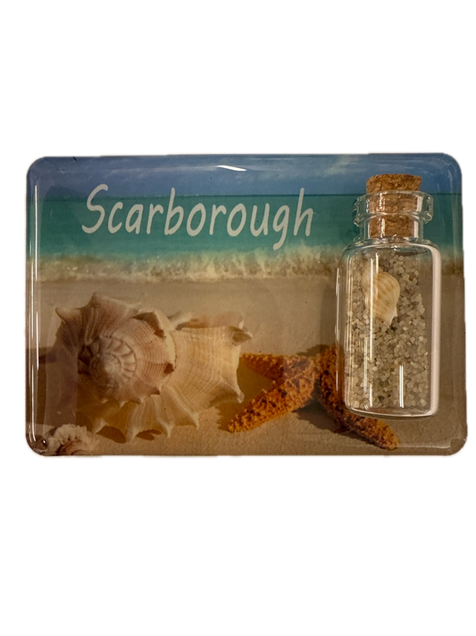 Fridge magnet with seashells and a bottle containing sand, labeled 'Scarborough'.