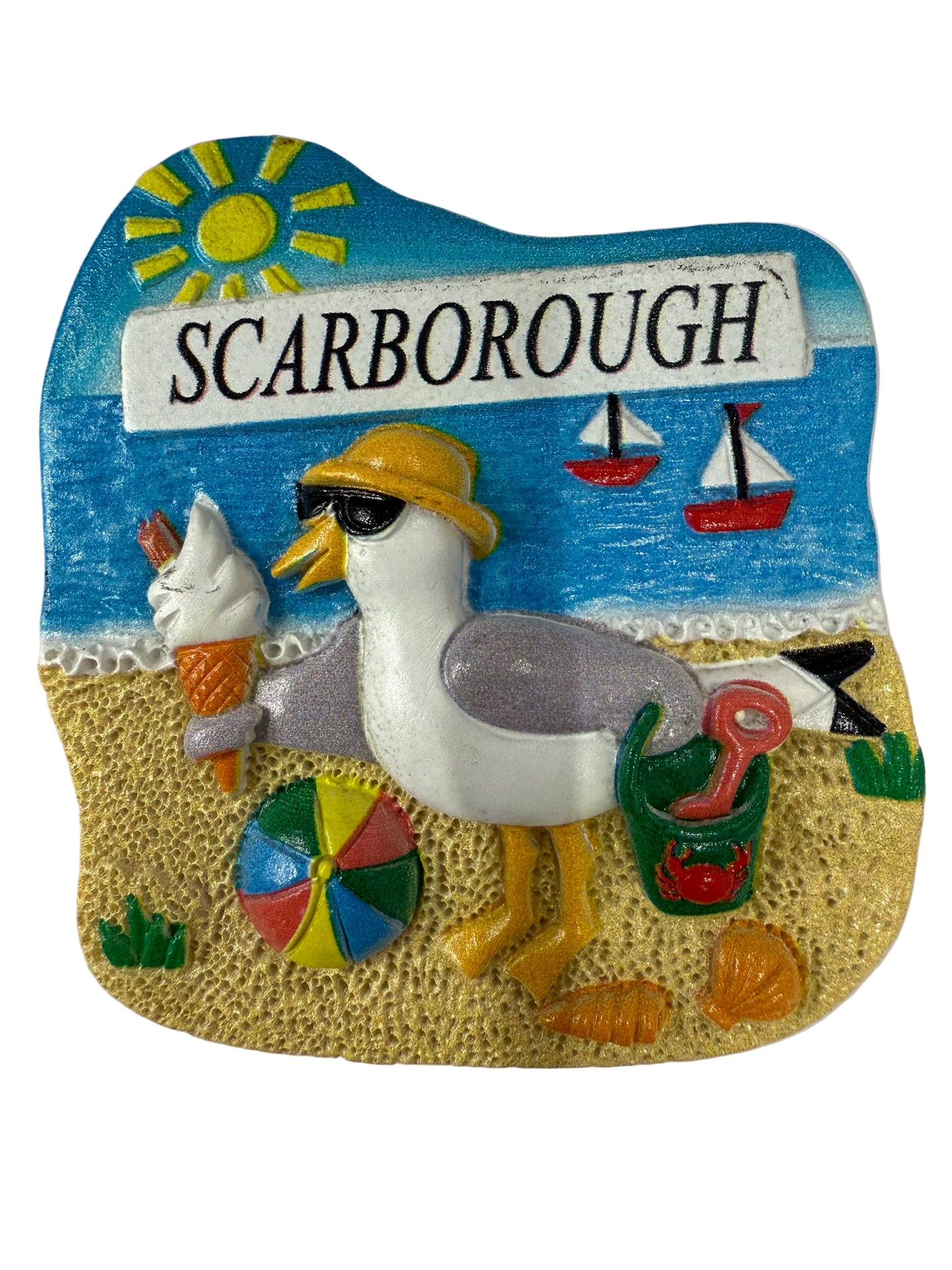 Decorative magnet with a seagull, ice cream cone, and 'Scarborough' sign on a beach scene.