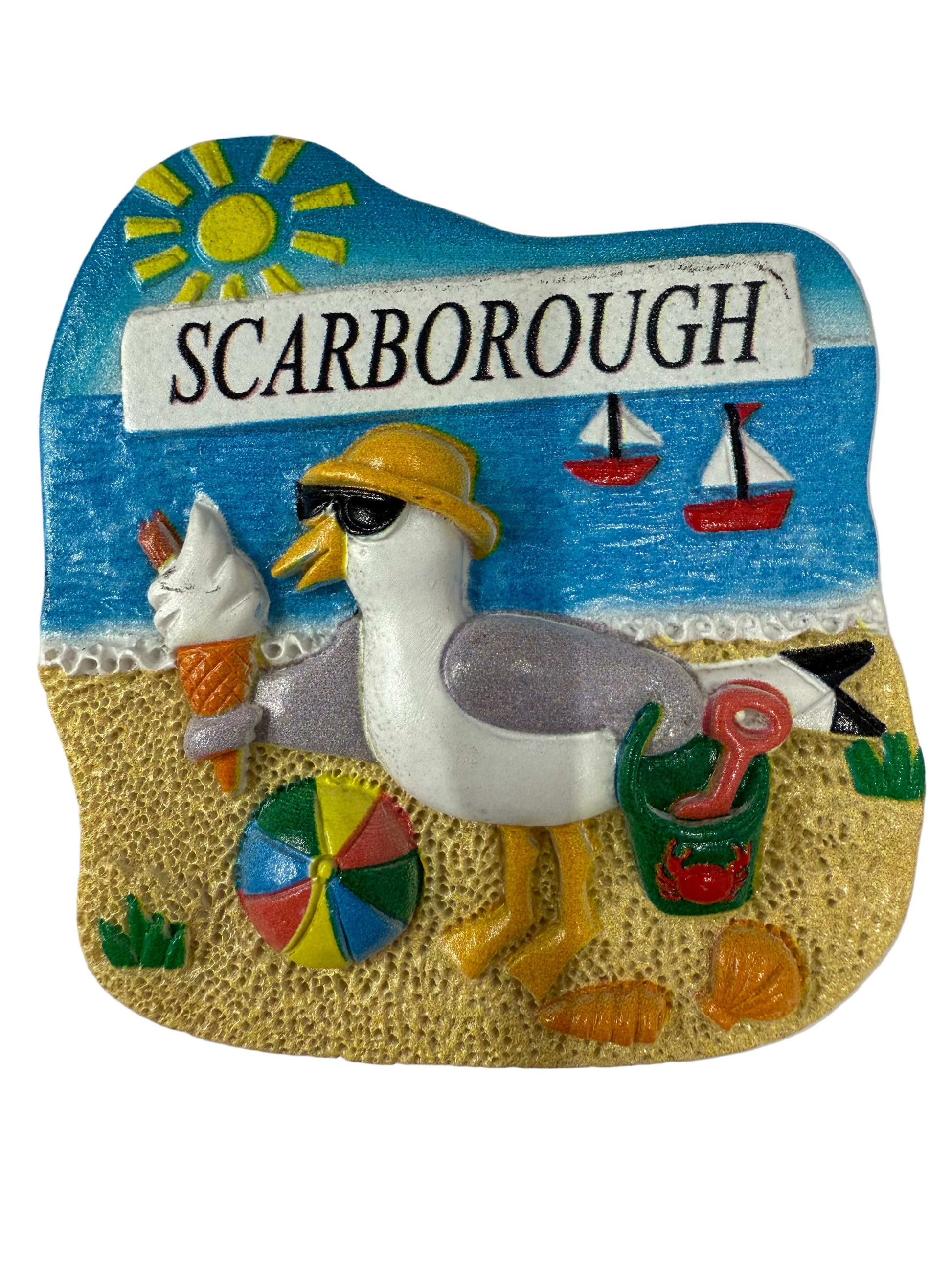 Decorative magnet with a seagull, ice cream cone, and 'Scarborough' sign on a beach scene.