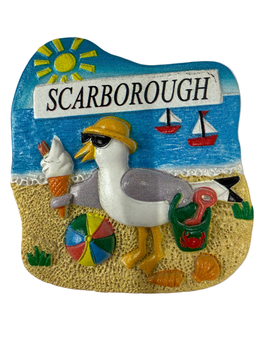 Decorative magnet with a seagull, ice cream cone, and 'Scarborough' sign on a beach scene.