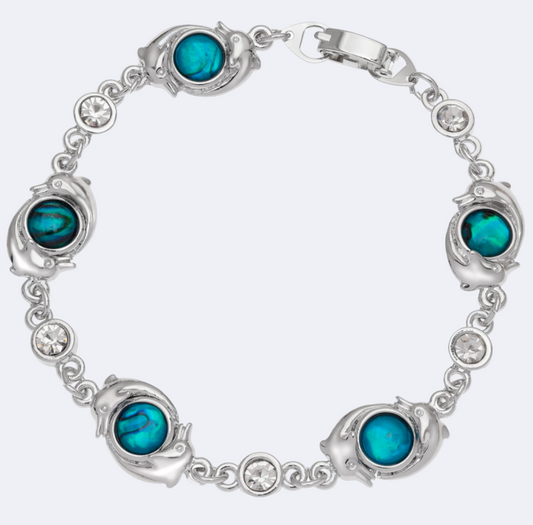 A silver-colored dolphin bracelet with blue paua shell inserts and glass crystal spacers, displayed against a white background.