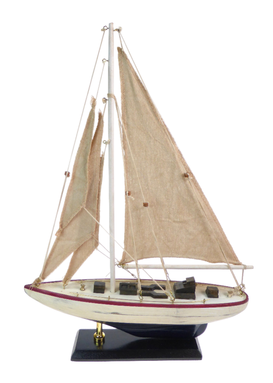 Model sailboat with beige sails on a white background