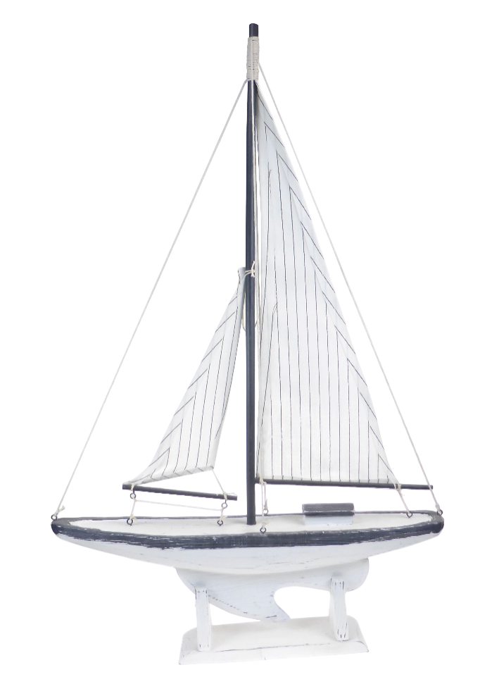 Model sailboat with white sails on a white background