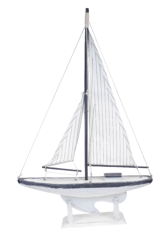Model sailboat with white sails on a white background