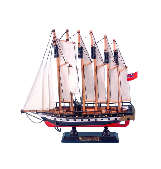 Model ship with multiple masts and sails on a light blue background
