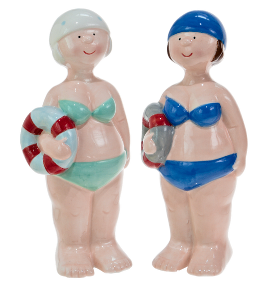 Two ceramic figures of women in swimsuits with life preservers on a white background