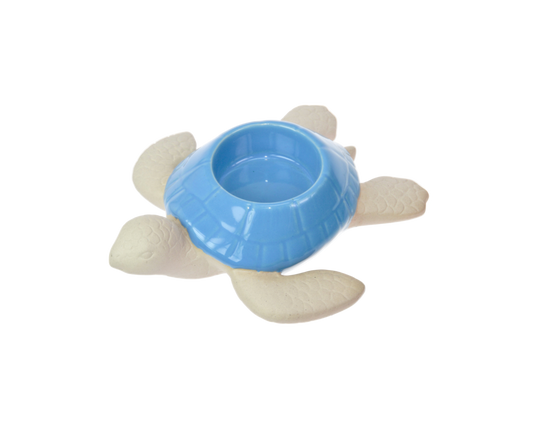 Blue turtle-shaped ornament with tealight holder in the shell on a white background