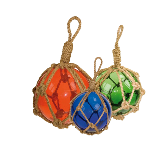 Three colorful glass floats in red, blue, and green, each tied with a rope net on a white background.