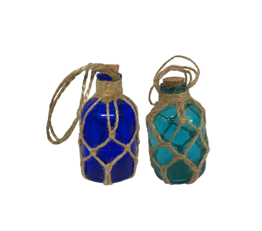 Two blue glass bottles with rope netting on a white background