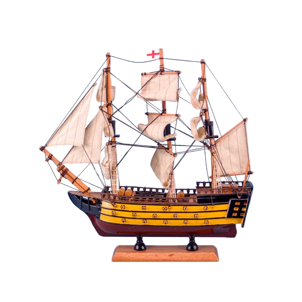 Model ship with multiple sails on a light blue background