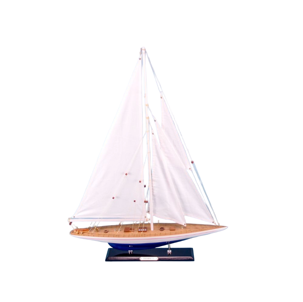 Model sailboat with white sails on a light blue background