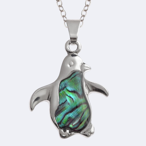Penguin-shaped pendant with abalone shell inlay on a white background
