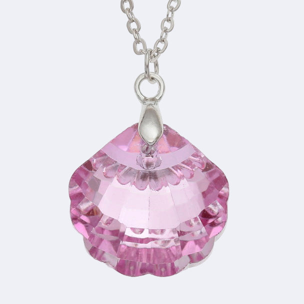 Pink crystal pendant on a silver chain against a white background