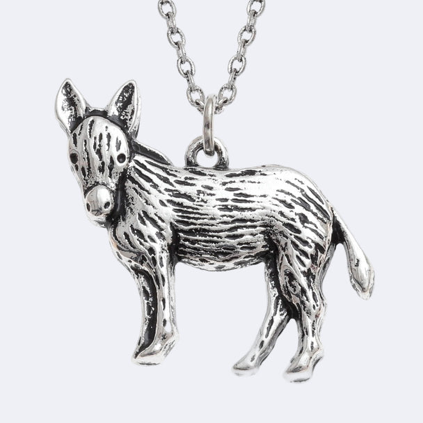 Silver donkey pendant on a chain against a white background
