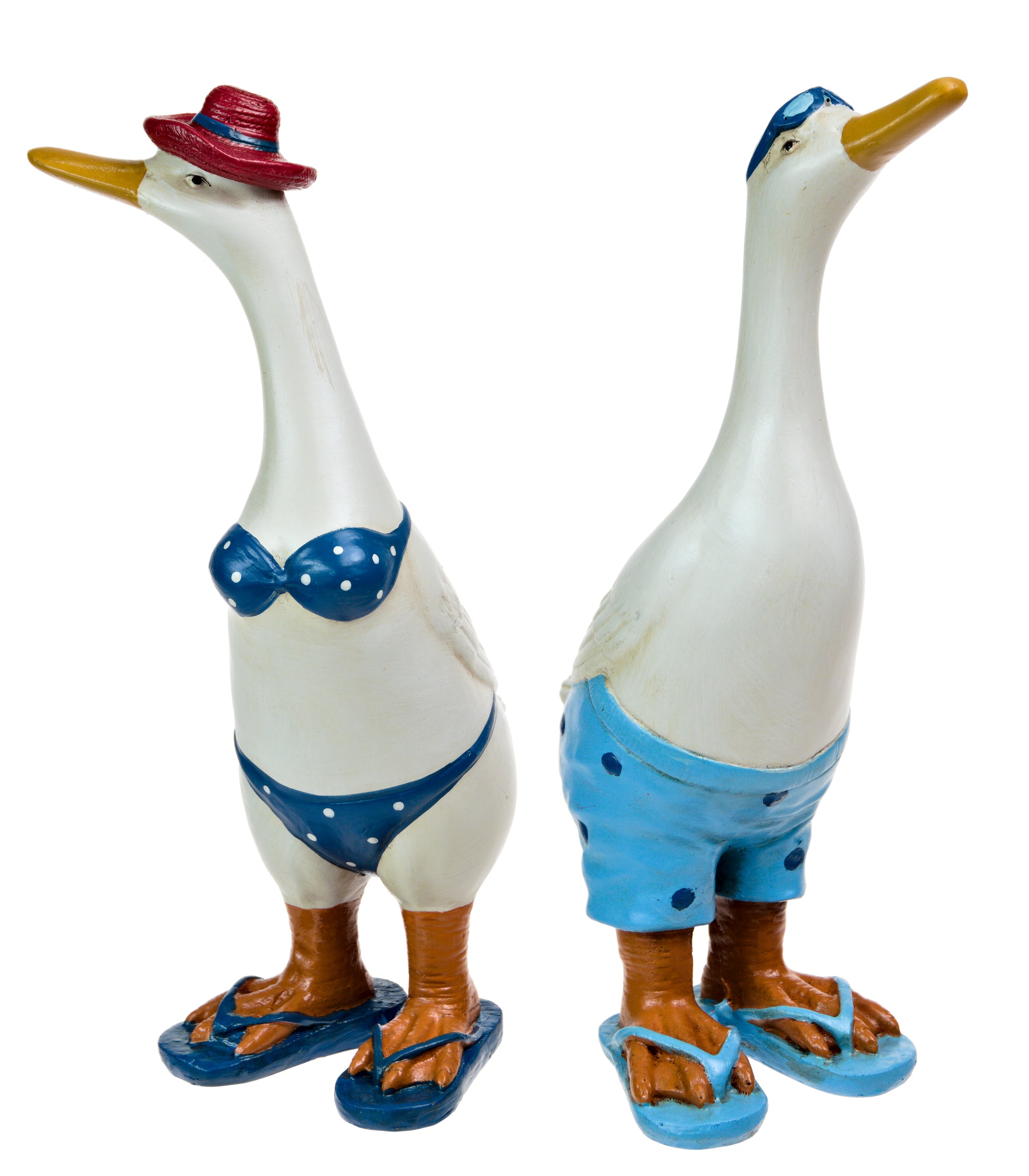 Two resin ducks, one dressed in a blue and white bikini and the other in a blue shorts and flip-flops, with a male duck wearing a red hat.