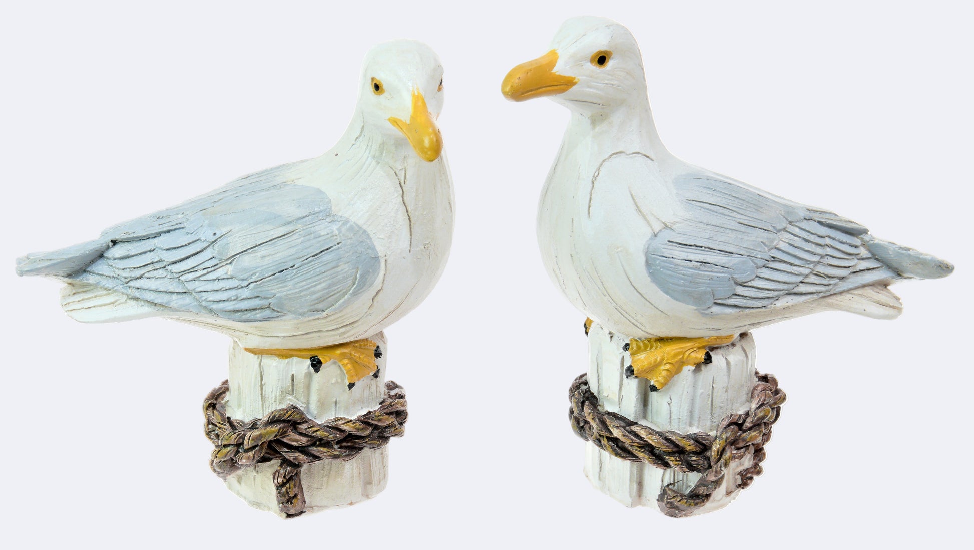 Two resin seagull figurines with assorted styles, perched on a faux rope base.