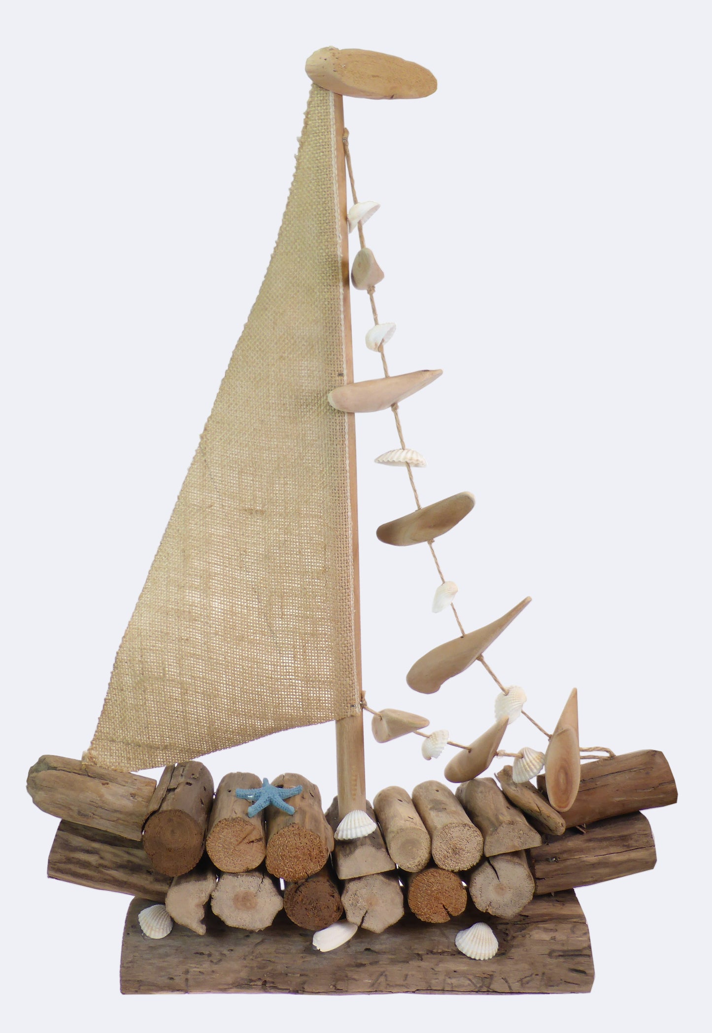 A decorative boat made out of driftwood with a sail and seashells.