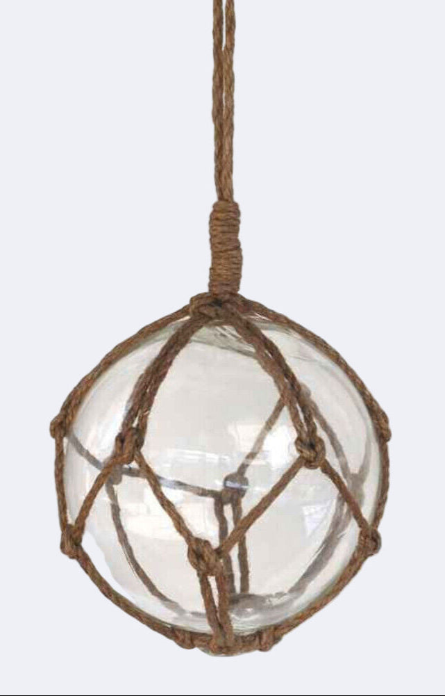 Clear glass ball with brown rope netting hanging on a white background